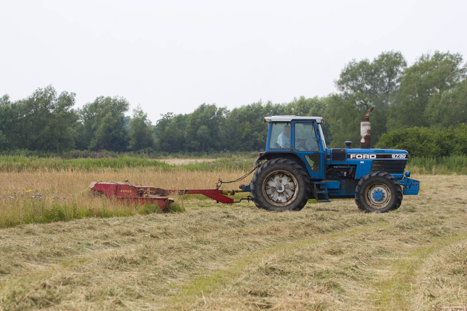 Image of tractor cutting meadow - copyright Mike Dodd