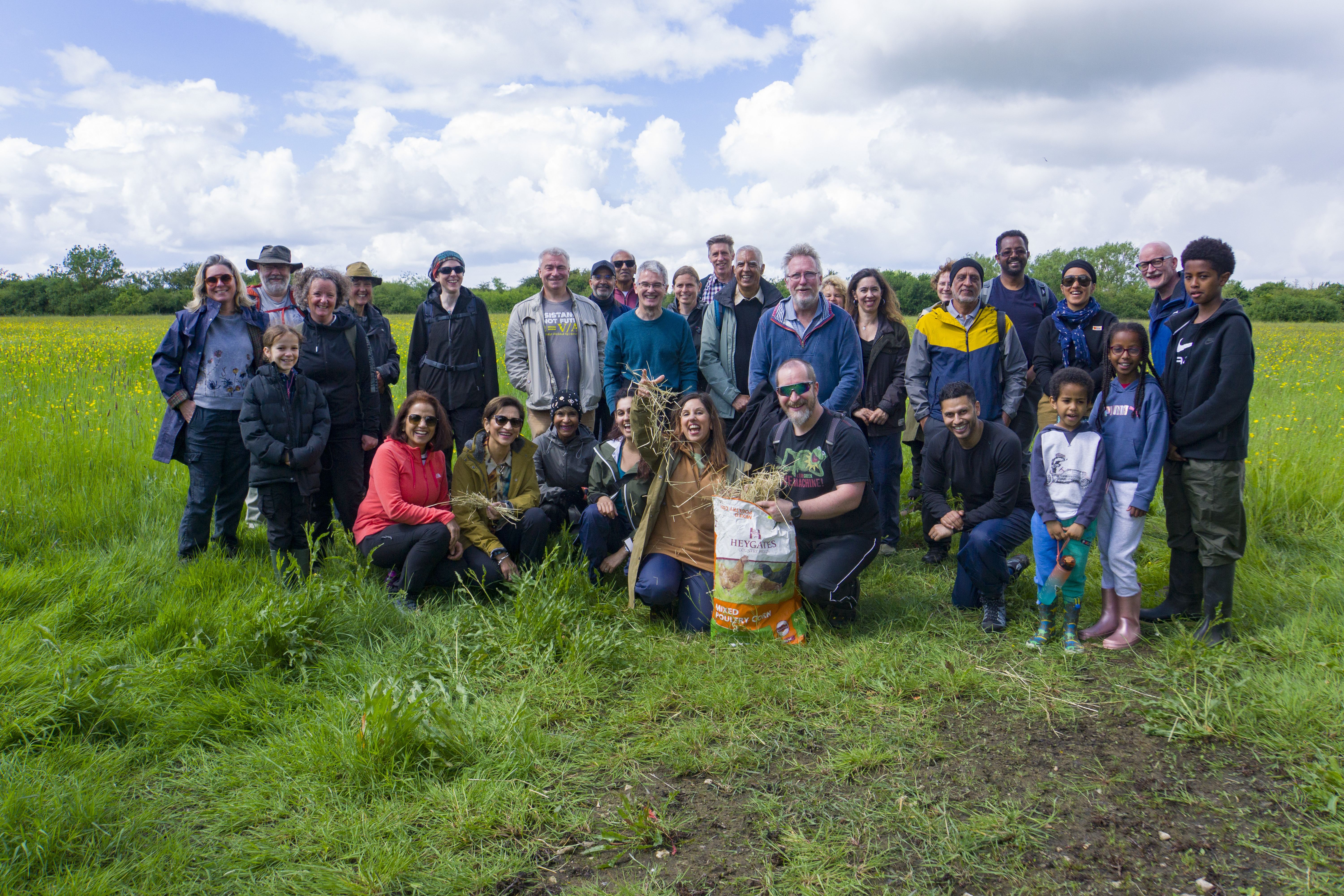 Group photo of event participants standing in a meadow. Image credit: Sivi Sivanesan