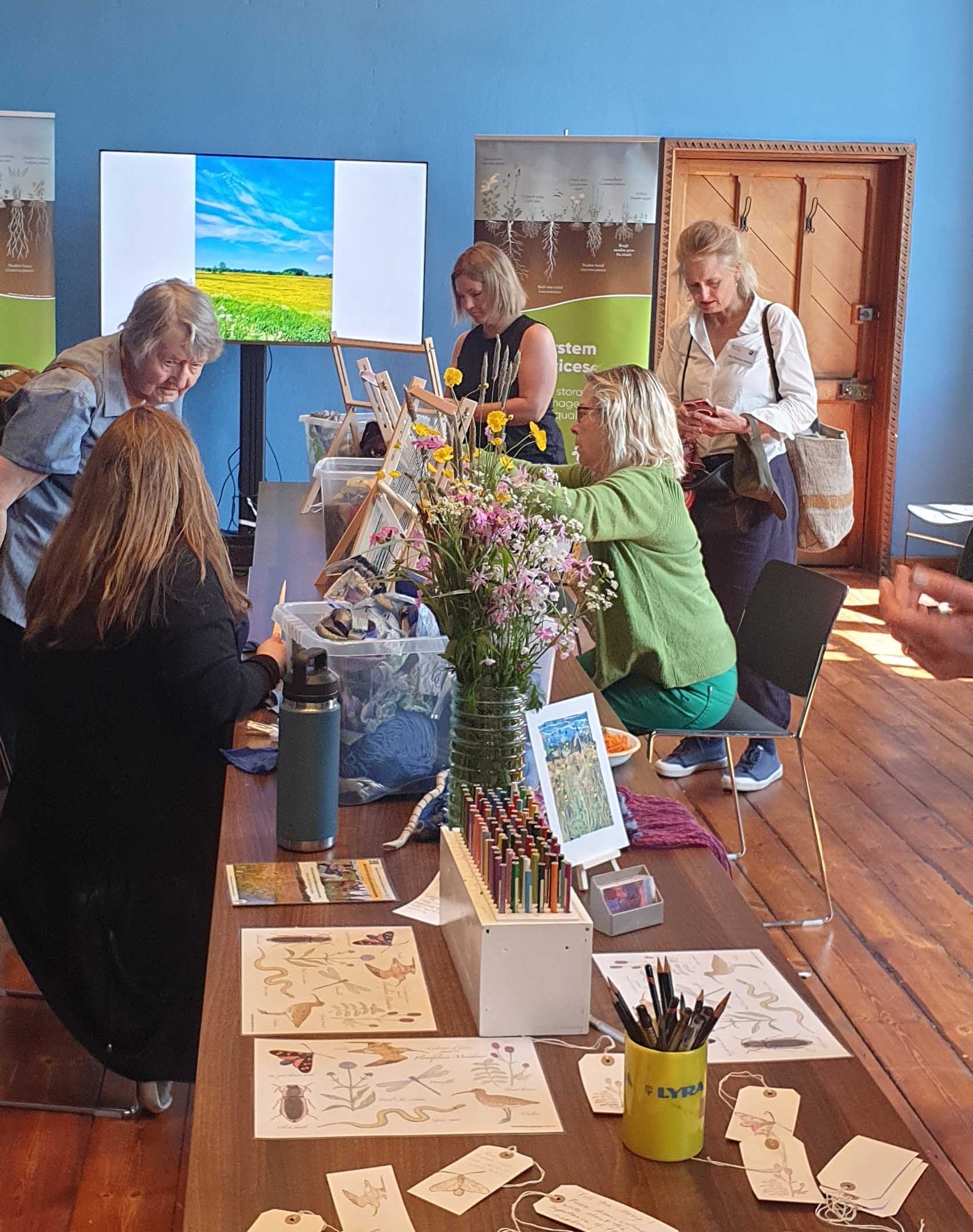 Delegates weaving at a table